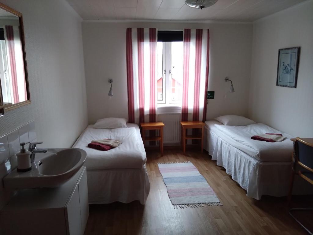 Postel nebo postele na pokoji v ubytování Hotell Hemgården
