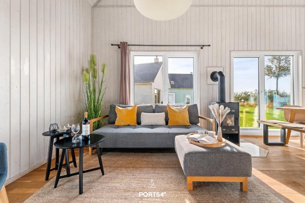 a living room with a couch and a table at Ferienhaus Olpi Olpenitz in Olpenitz