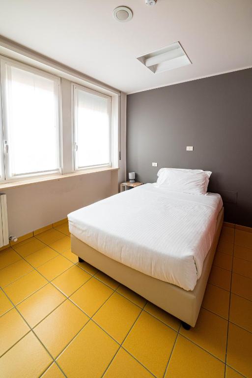Postel nebo postele na pokoji v ubytování Phi Hotel Homy Druento