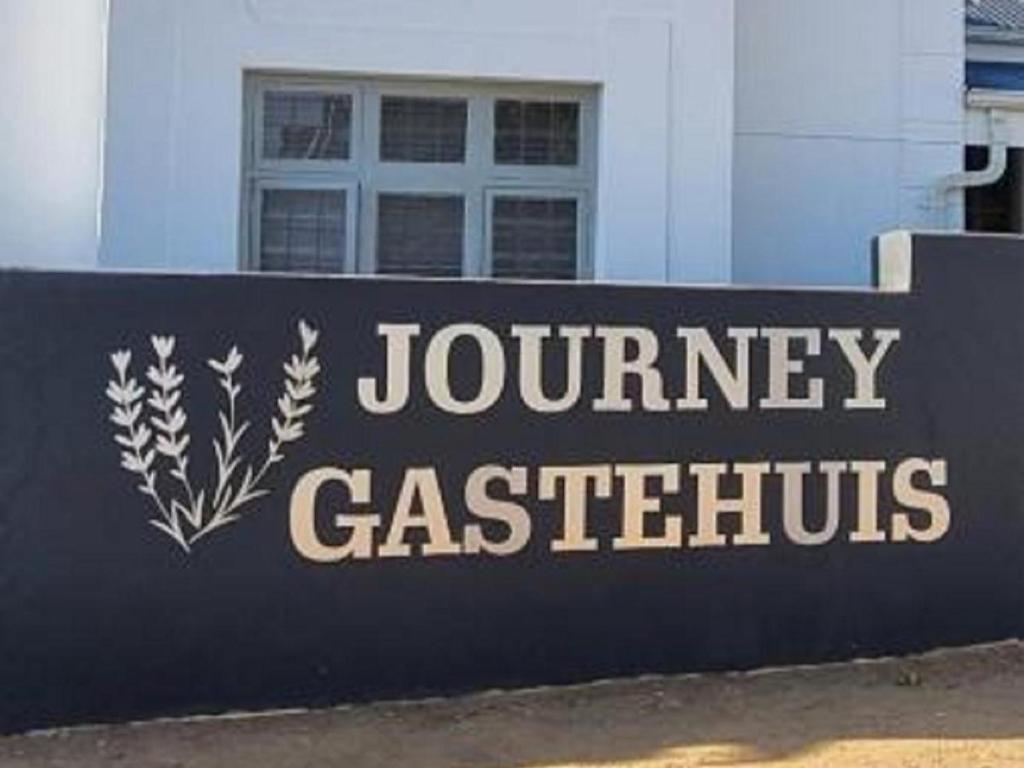 a sign that reads journey casertives on a building at Journey Guesthouse in Riversdale