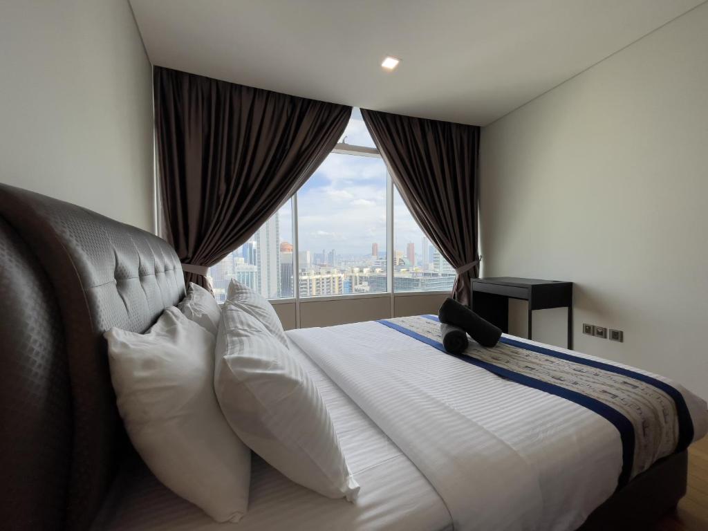 Postel nebo postele na pokoji v ubytování Vortex Suites klcc By Sayang