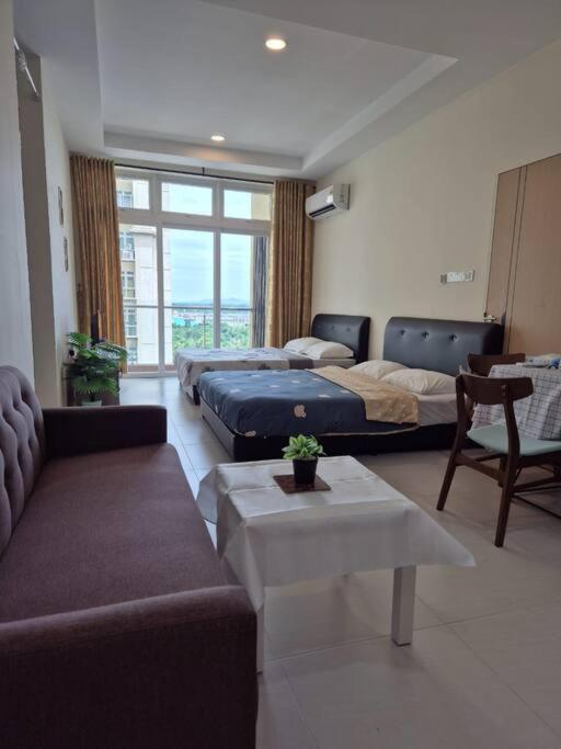 a living room with two beds and a couch at Good view stay in Kuching