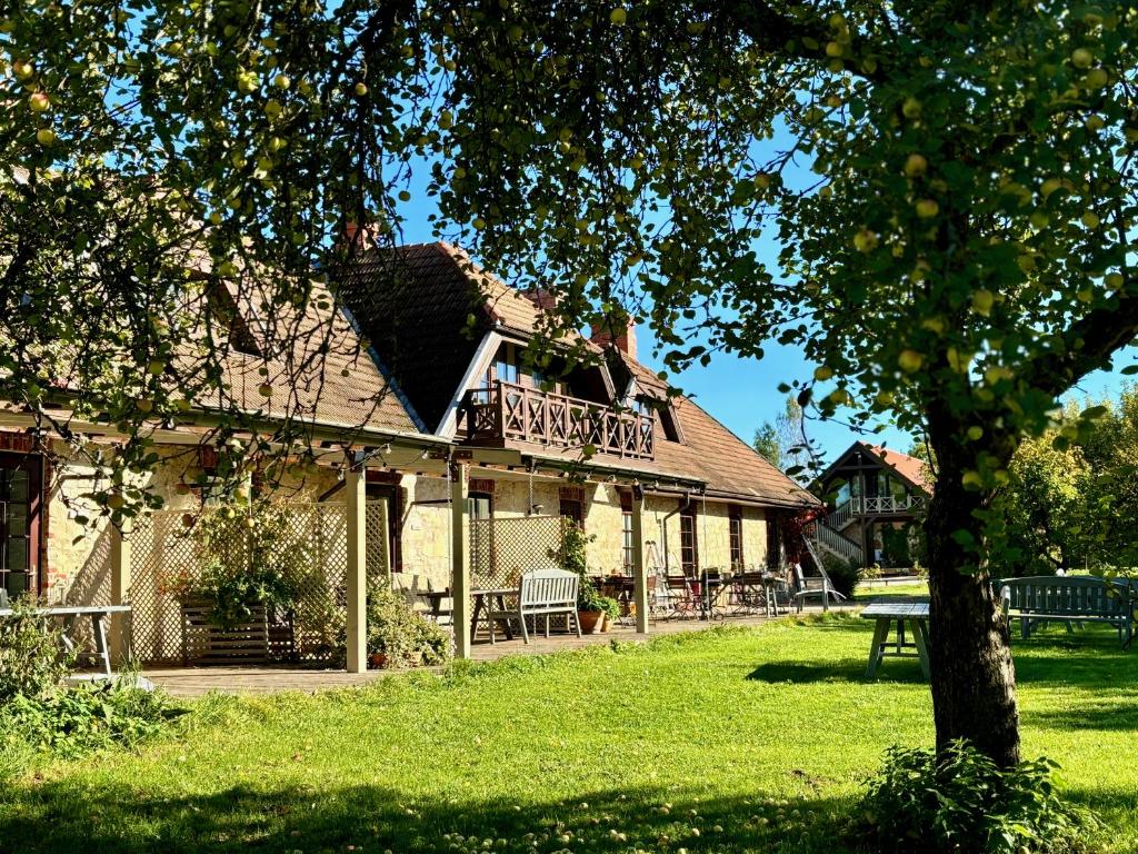 a house with a deck on the side of it at Karlamuiza Country Hotel in Kārļi