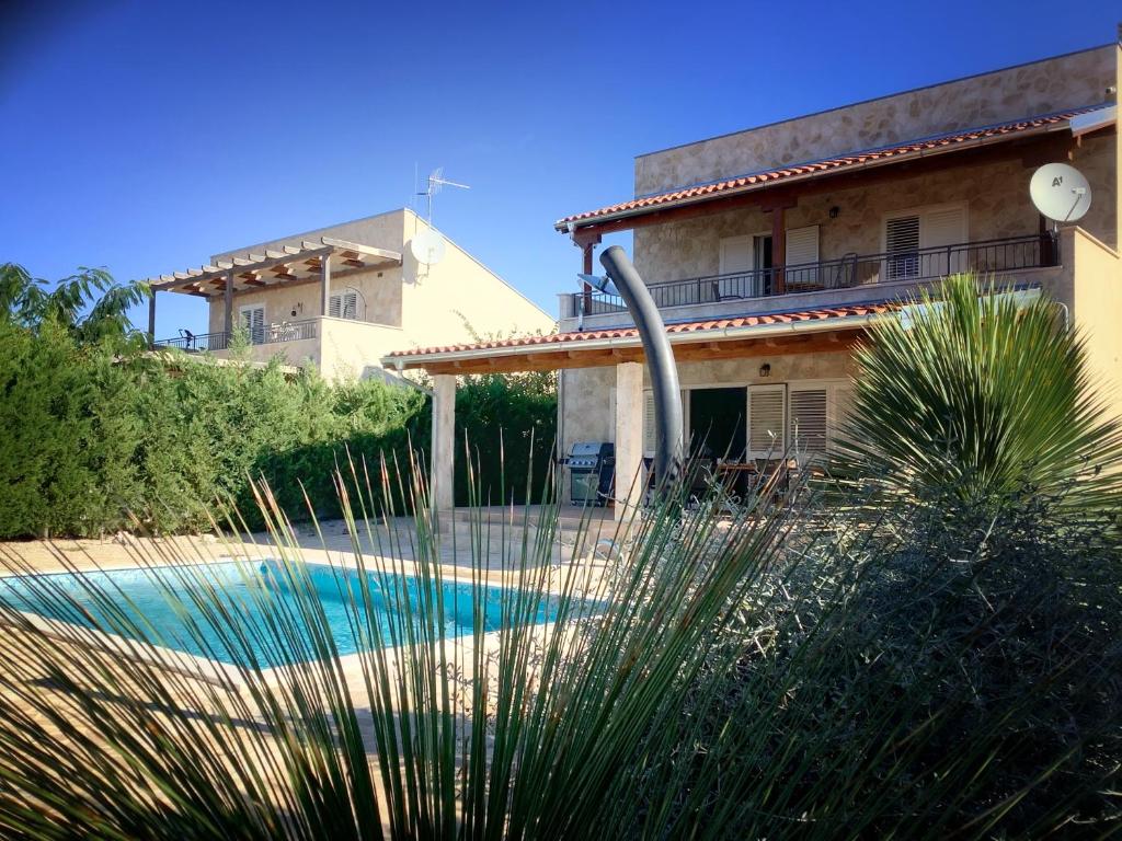 a house with a swimming pool in front of a house at Villa hygge in Šibenik