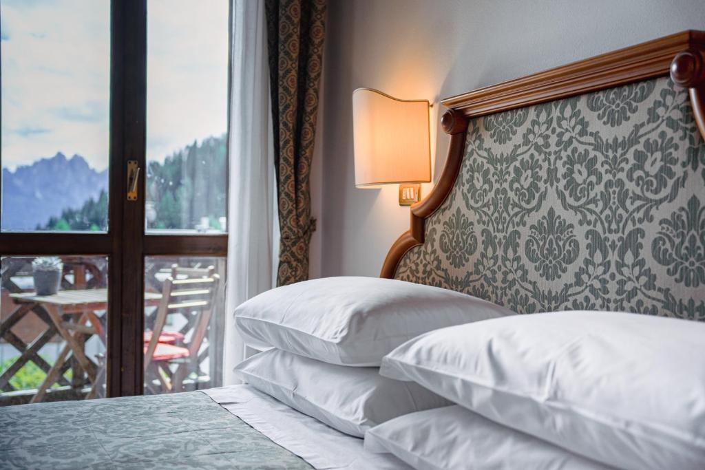 Postel nebo postele na pokoji v ubytování Hotel Sporting