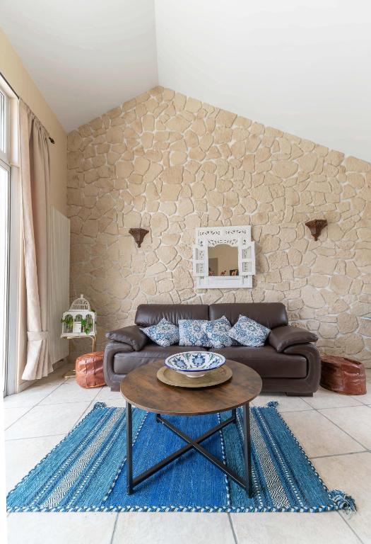 a living room with a couch and a table at La Petite Maison Gannat in Gannat