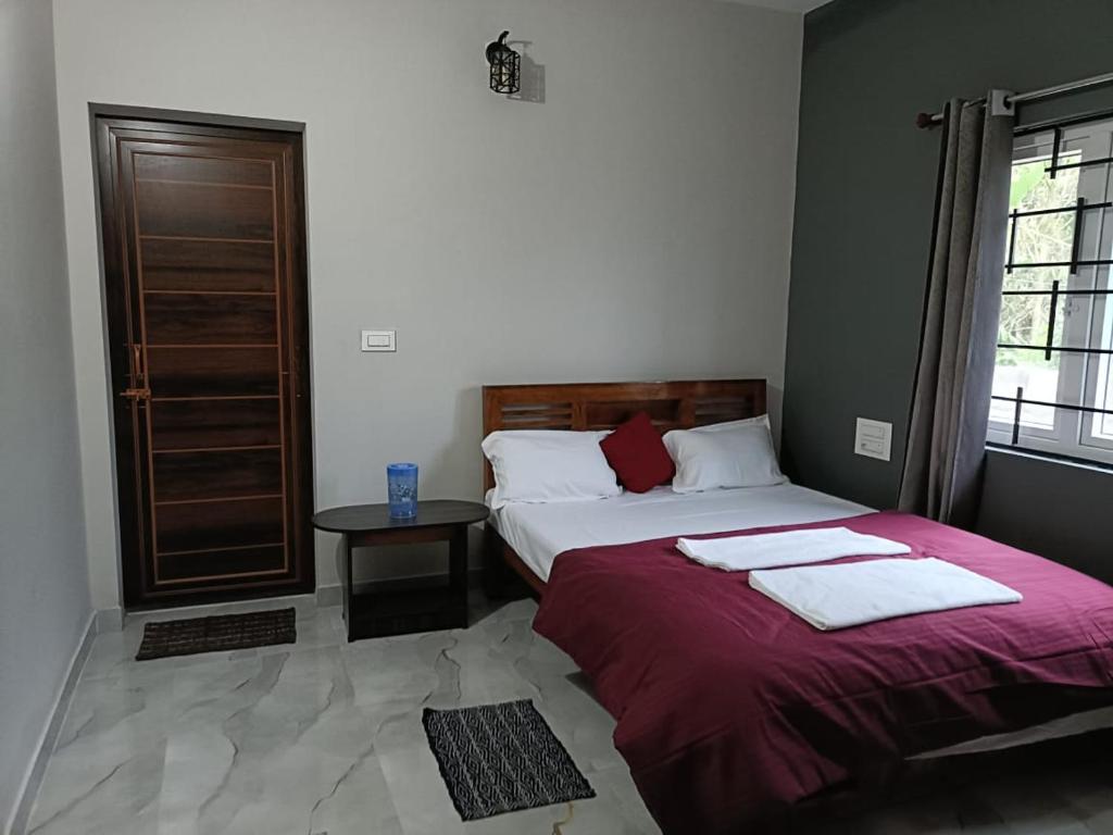 a bedroom with two beds and a window at Coorg wildstone Homestay in Madikeri