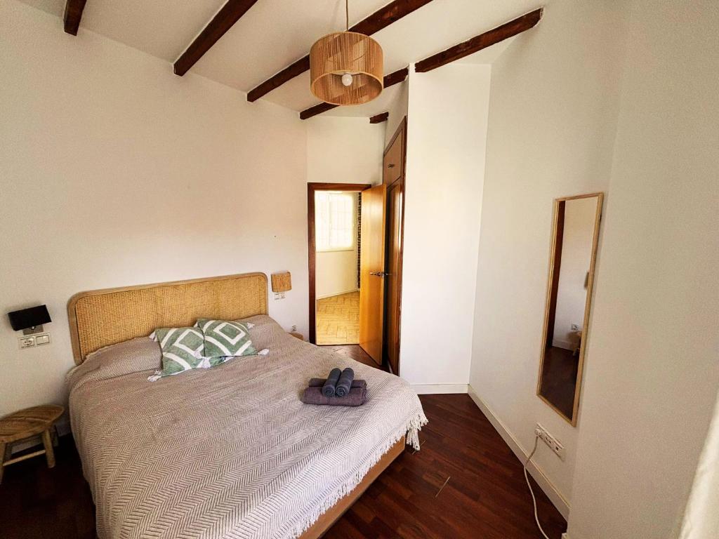 a bedroom with a bed with a pair of shoes on it at Encantador piso en Benimaclet in Valencia
