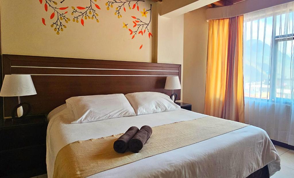Postel nebo postele na pokoji v ubytování Hotel Tungurahua