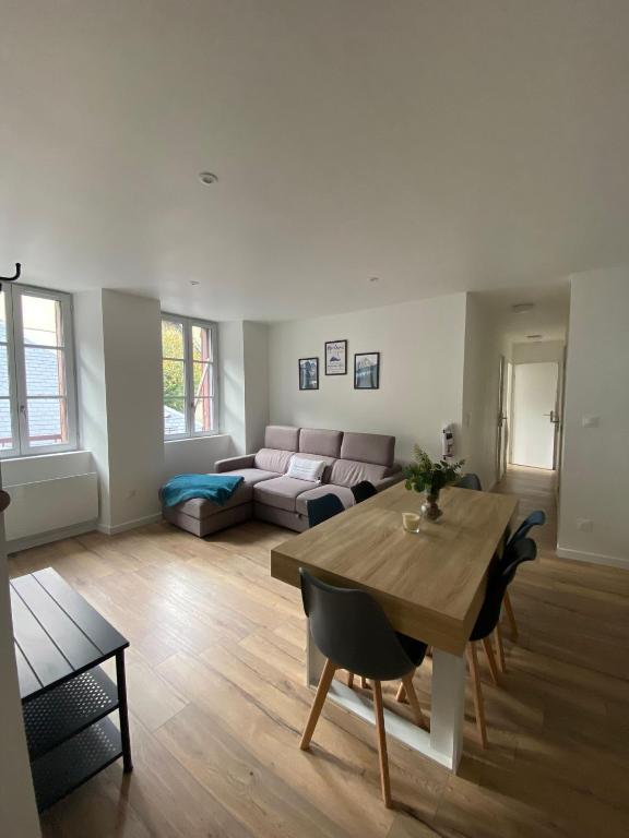 un salon avec une table et un canapé dans l'établissement Les Pics du Courtat, à Luchon