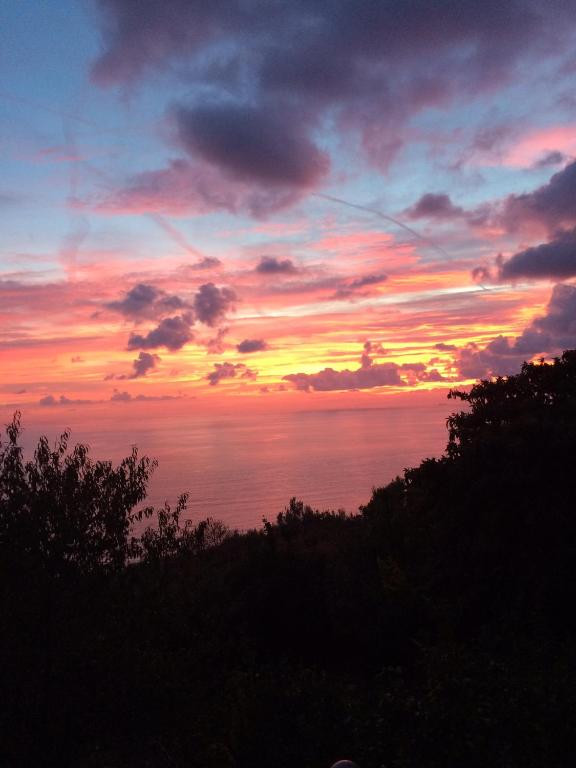 a sunset over the ocean with the sky at Agriturismo S.Ilario in Genoa