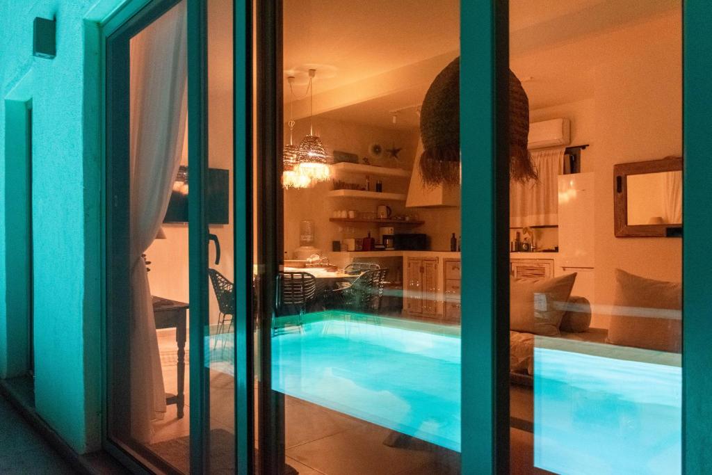 a swimming pool in a room with a kitchen at Deja Blue Villa 1 in Agios Georgios