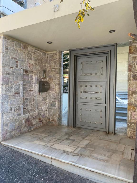 a garage door with a stone wall at Cosy House Glyfada in Athens