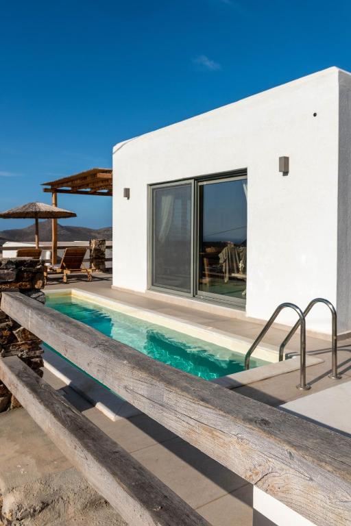 a house with a swimming pool next to a building at Deja blue villa 2 in Agios Georgios