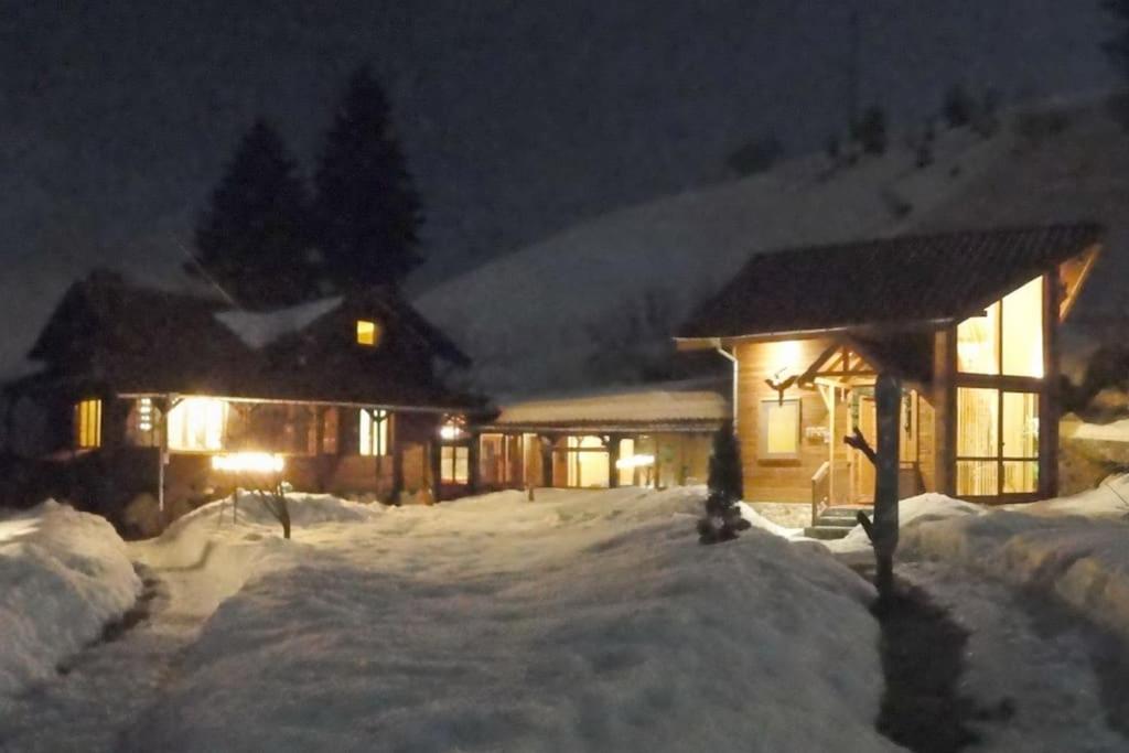 a cabin in the snow at night with lights at Ski liviomoritz at gma il com Chalet in Madzhare