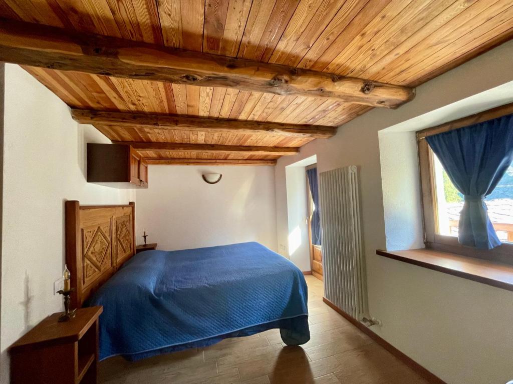 Postel nebo postele na pokoji v ubytování Abri Vigneroisa appartamento Miserin