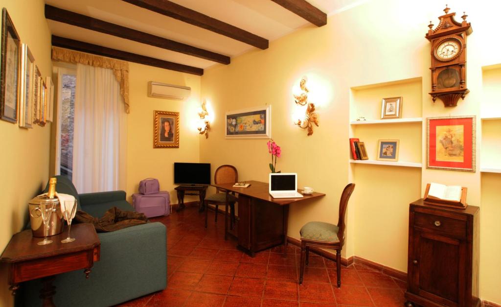 a living room with a couch and a desk with a computer at Navona Little Home in Rome