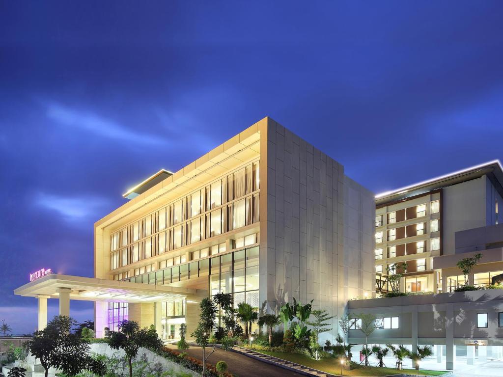 a rendering of a hotel building at night at Mercure Padang in Padang