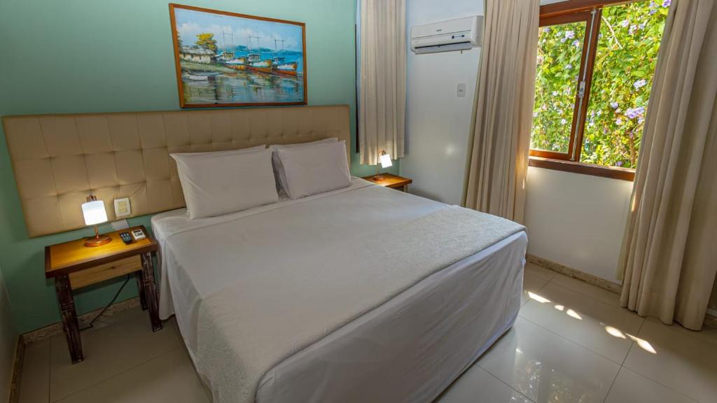 Postel nebo postele na pokoji v ubytování Enseada dos Corais Praia Hotel