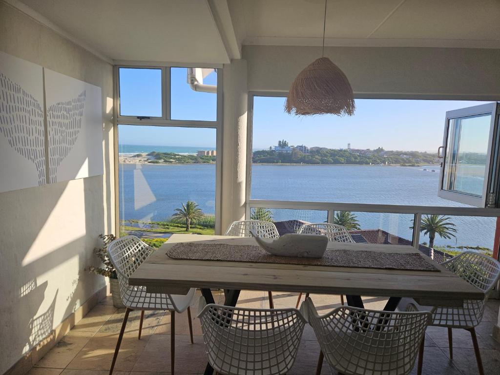 a dining room with a view of the water at Be Lazy with a Sea View in Jeffreys Bay