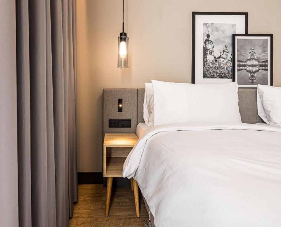 Postel nebo postele na pokoji v ubytování Radisson Hotel Leipzig