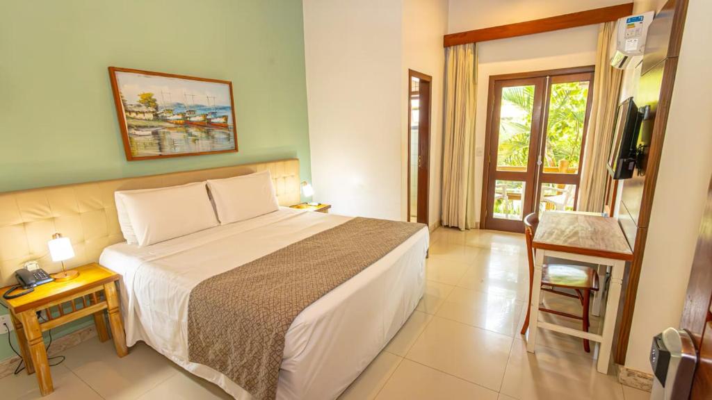 Postel nebo postele na pokoji v ubytování Enseada dos Corais Praia Hotel