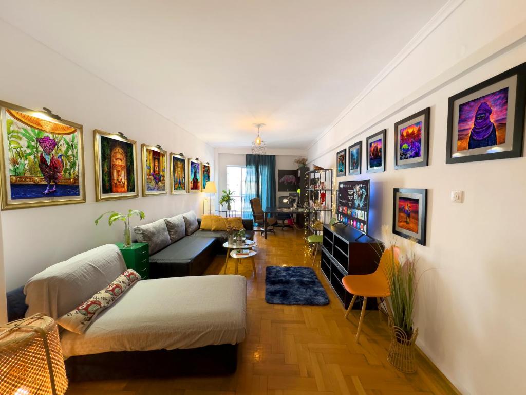a living room with a lot of paintings on the walls at Spacious Artistic Flat With Private Parking in Thessaloniki
