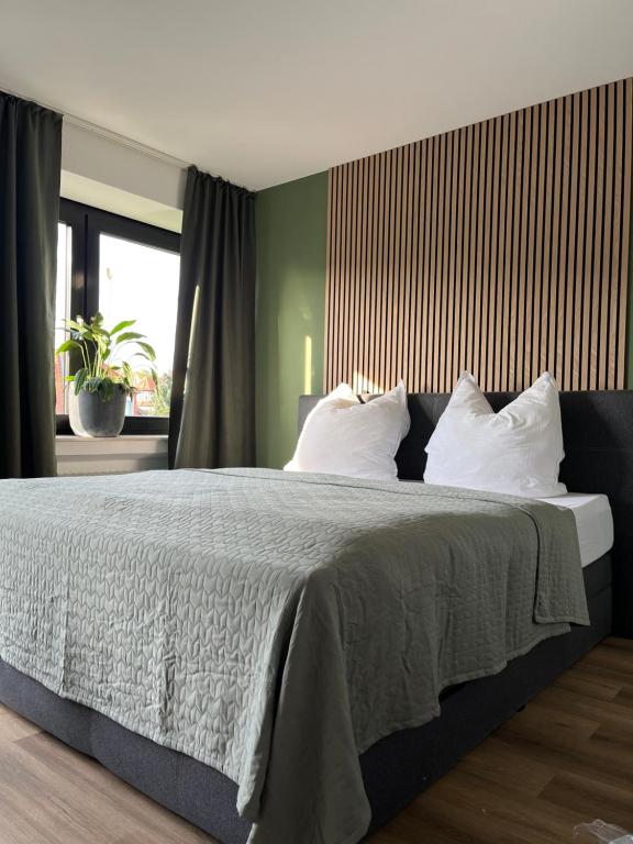 a bedroom with a large bed with white pillows at Auszeit am Kurpark I 24h Check-In I WLAN in Bad Salzuflen