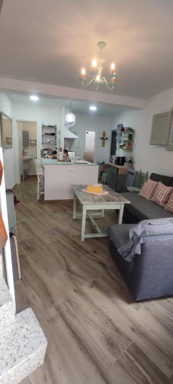 a living room with a couch and a table at La Casita El Carmen in Quintanar de la Orden