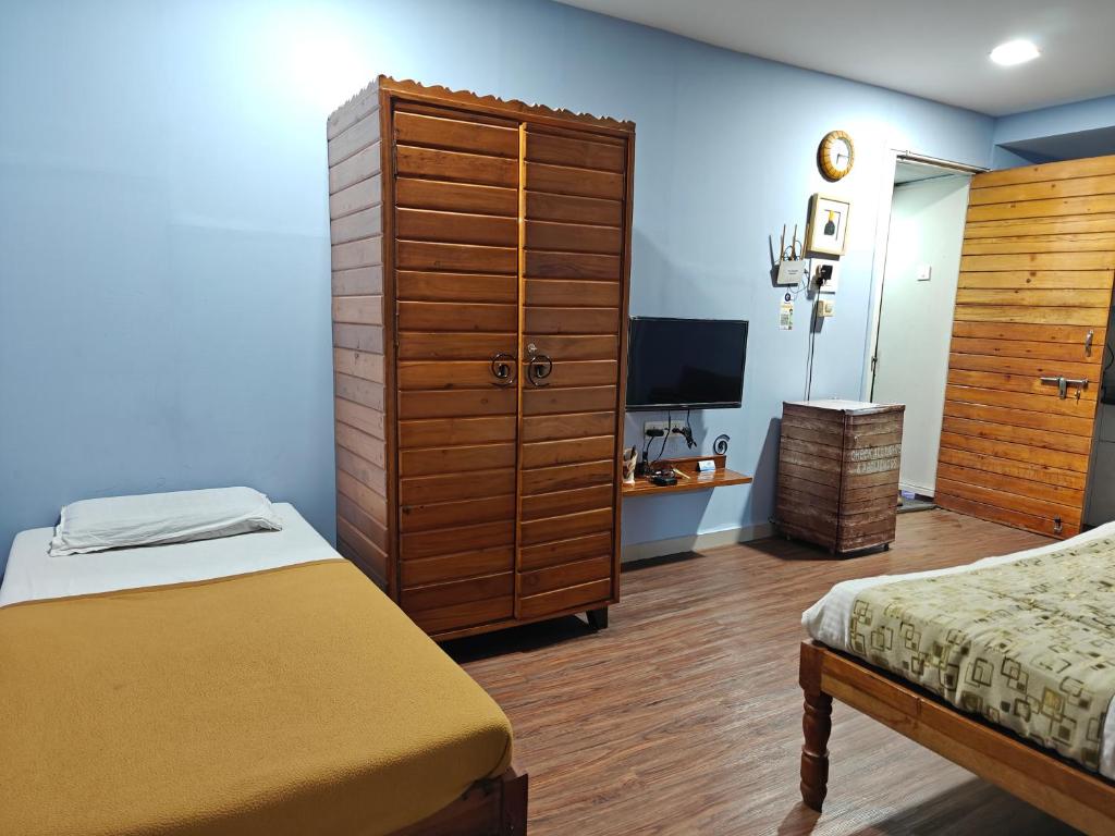 Postel nebo postele na pokoji v ubytování Chandralok Service Apartments
