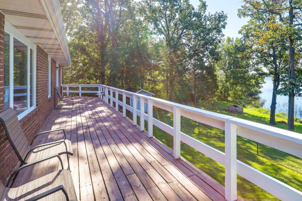 a wooden deck with a bench on a house at Lakefront Arkansas Escape with Grill, Dock and Kayaks! in Horseshoe Bend