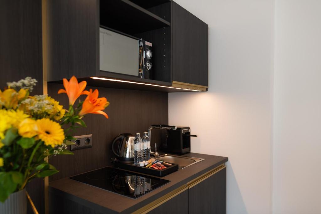 Kuchyň nebo kuchyňský kout v ubytování Florum Hotel