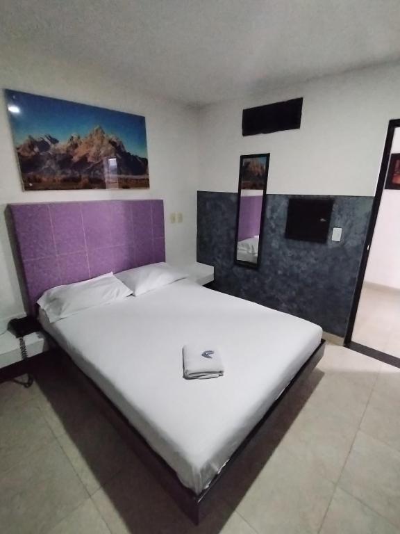 Postel nebo postele na pokoji v ubytování Hotel Medellin Park