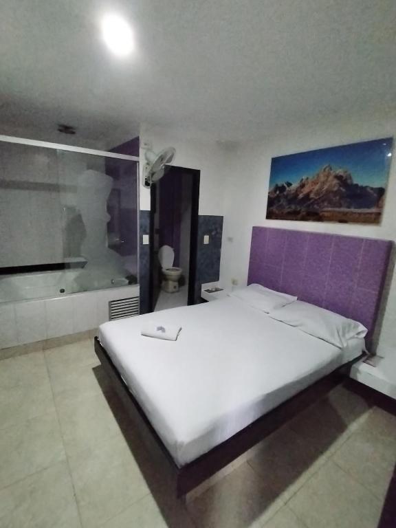 Postel nebo postele na pokoji v ubytování Hotel Medellin Park