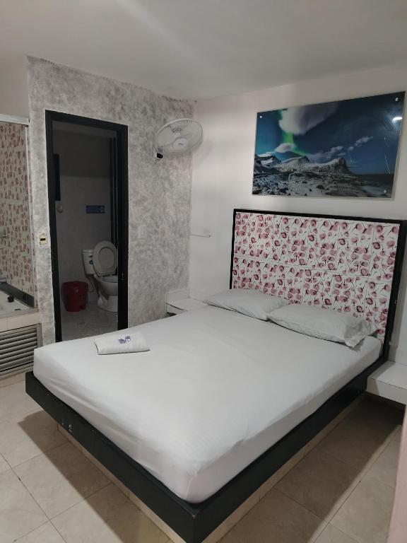 Postel nebo postele na pokoji v ubytování Hotel Medellin Park
