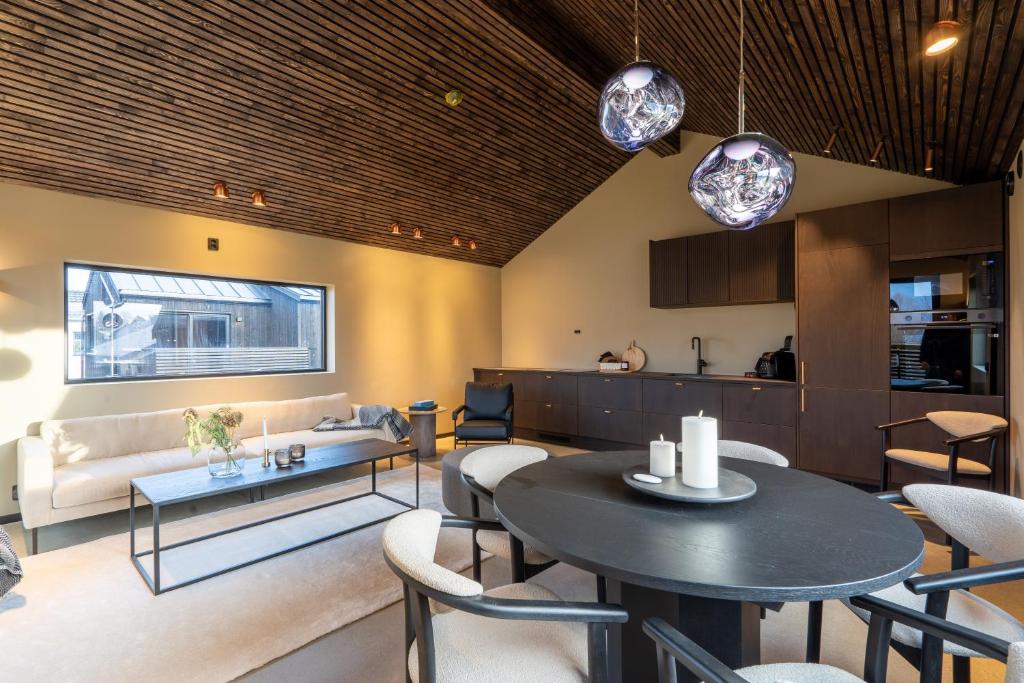 a living room with a couch and a table at Arctic Elegance in Tromsø