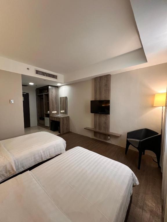 Postel nebo postele na pokoji v ubytování Ajang Hotel