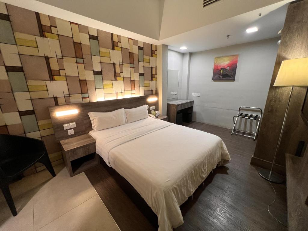 Postel nebo postele na pokoji v ubytování Ajang Hotel