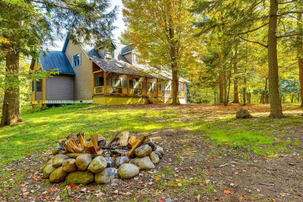 a pile of logs in front of a house at Private Deck and Fire Pit Adirondack Family Home in Old Forge