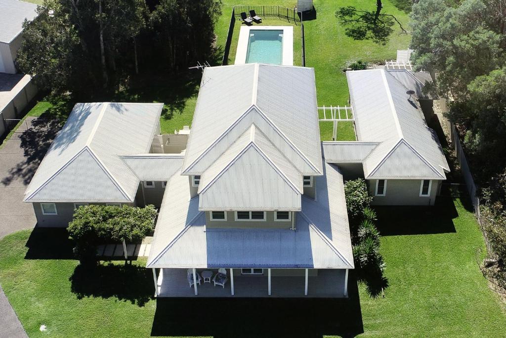 an overhead view of a house with a white roof at Echo Beach House in One Mile