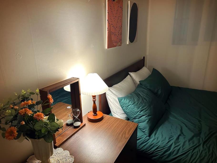 a living room with a bed and a table with a lamp at Clean & All new - Songridan-gil, Seokchon Lake, Lotte World, KSPO Dome, Olympic Park, Han River, Asan Hospital, Coex in Seoul
