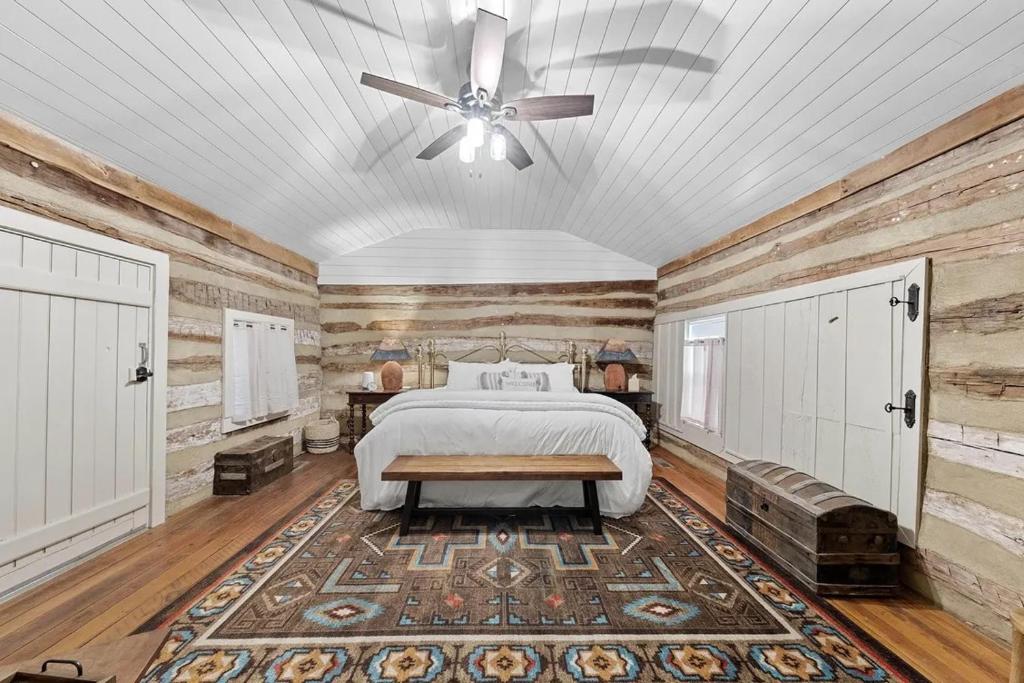 a bedroom with a bed and a ceiling fan at Rustic Augusta Cabin in Augusta