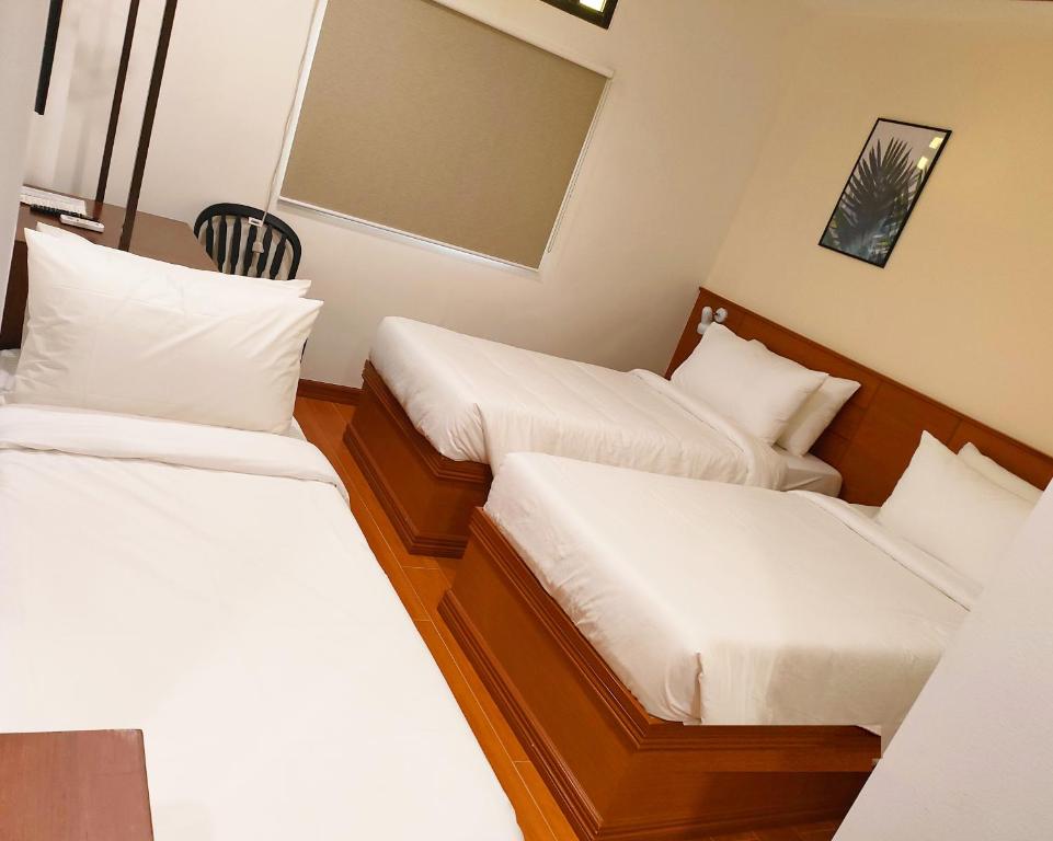 Postel nebo postele na pokoji v ubytování LaVie Hotel