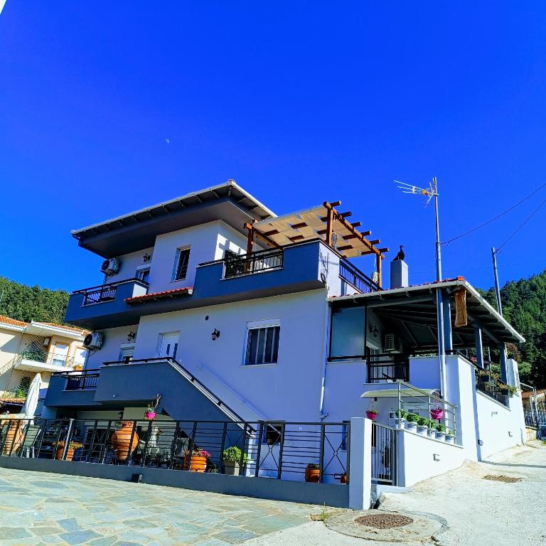 a large white building with a balcony at LASKARINA'S HOUSE in Skala Potamias