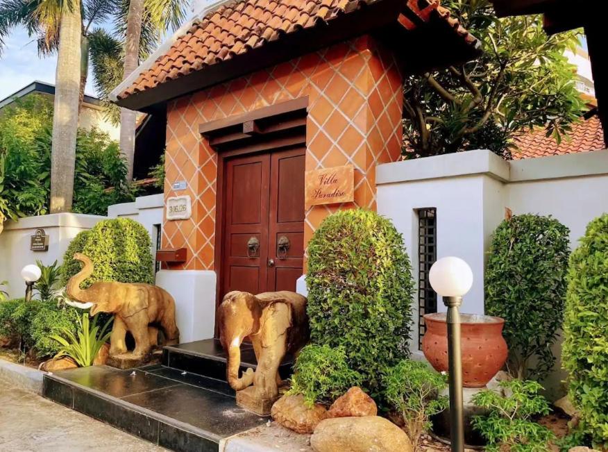 a small house with statues of elephants in front of it at Bali Style Luxury 400sqm Semi-4BED POOL VILLA near Beach & Walking Street in Jomtien Beach