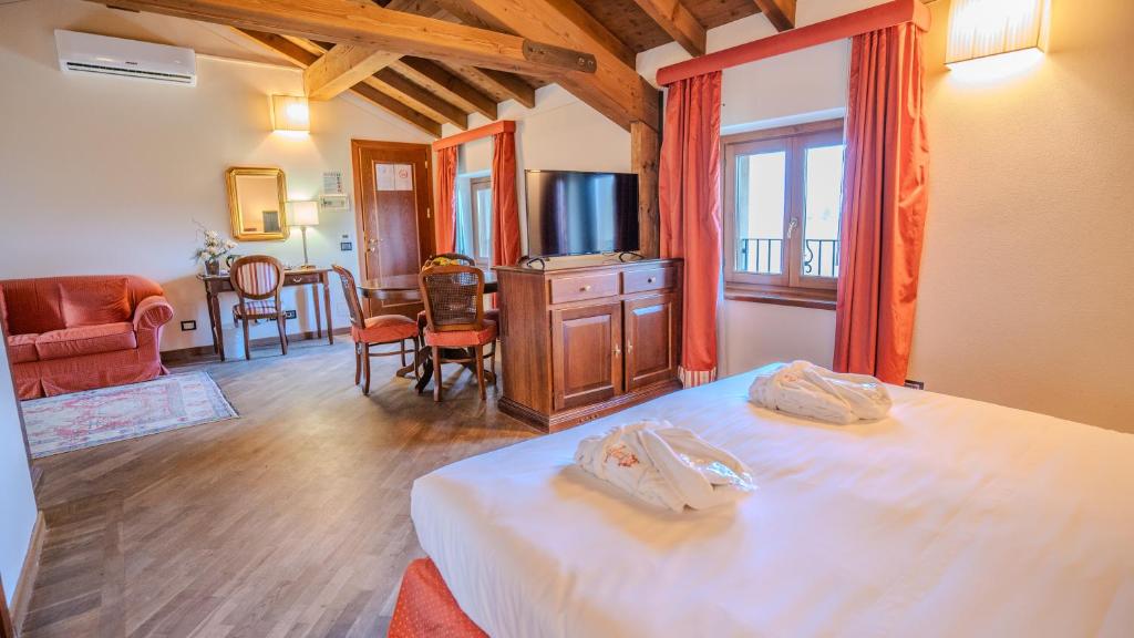 Postel nebo postele na pokoji v ubytování Relais Corte Cavalli