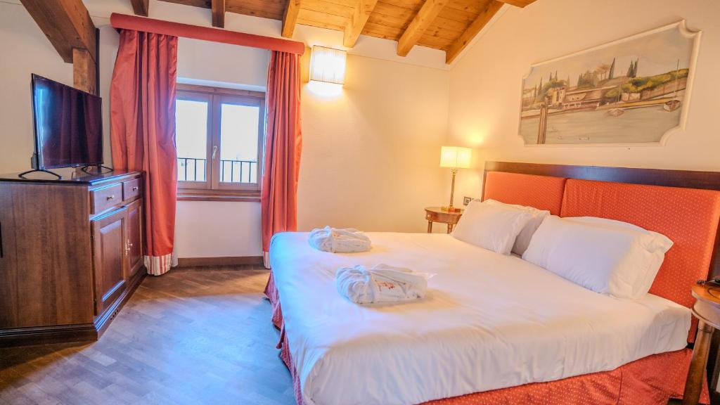 Postel nebo postele na pokoji v ubytování Relais Corte Cavalli