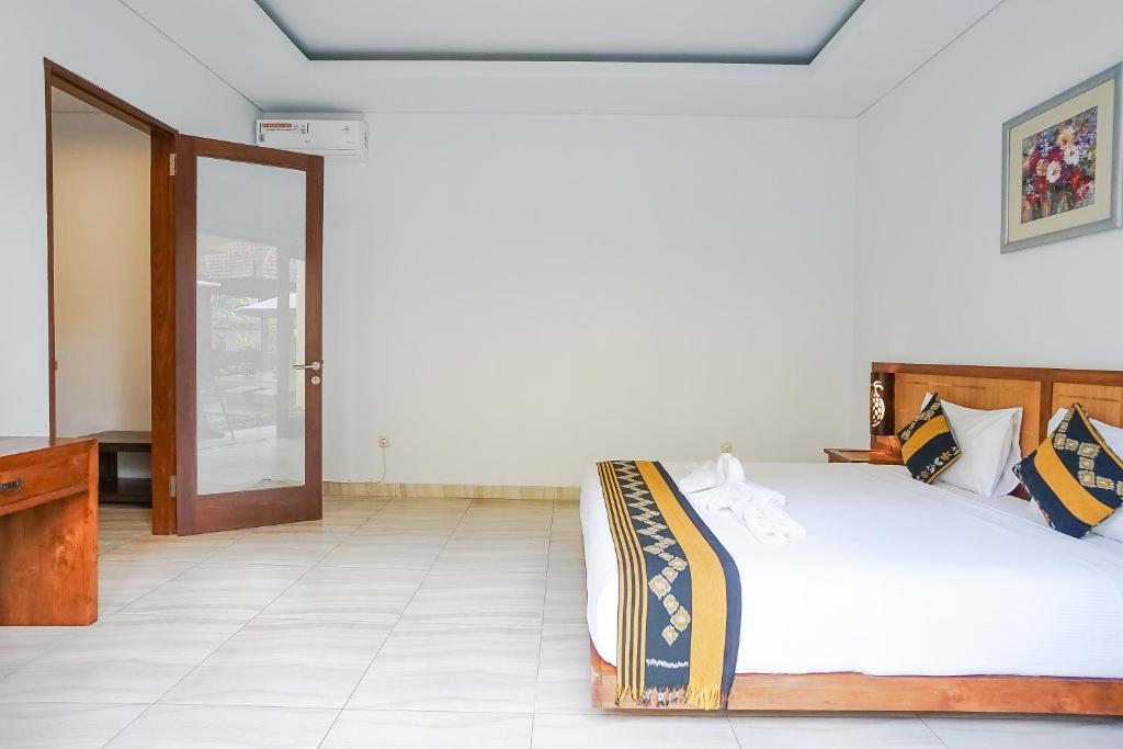 Postel nebo postele na pokoji v ubytování Toya Villa Ubud