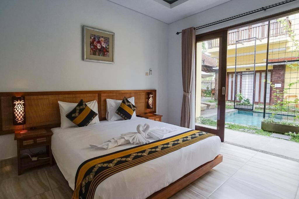 Postel nebo postele na pokoji v ubytování Toya Villa Ubud