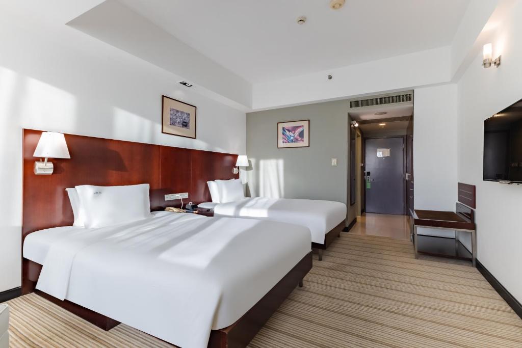 Postel nebo postele na pokoji v ubytování Holiday Inn Shanghai Vista by IHG - Easy access to travel spot city walk
